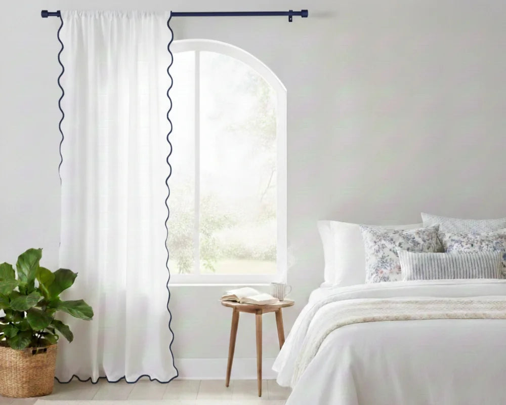 White curtain with Navy wavy side trim in a bedroom setting