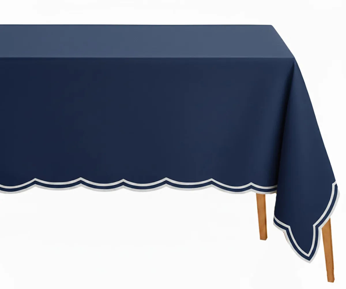Navy blue cotton rectangle tablecloth with intricate white scalloped embroidery, soft and durable, perfect for elegant dining and festive occasions.