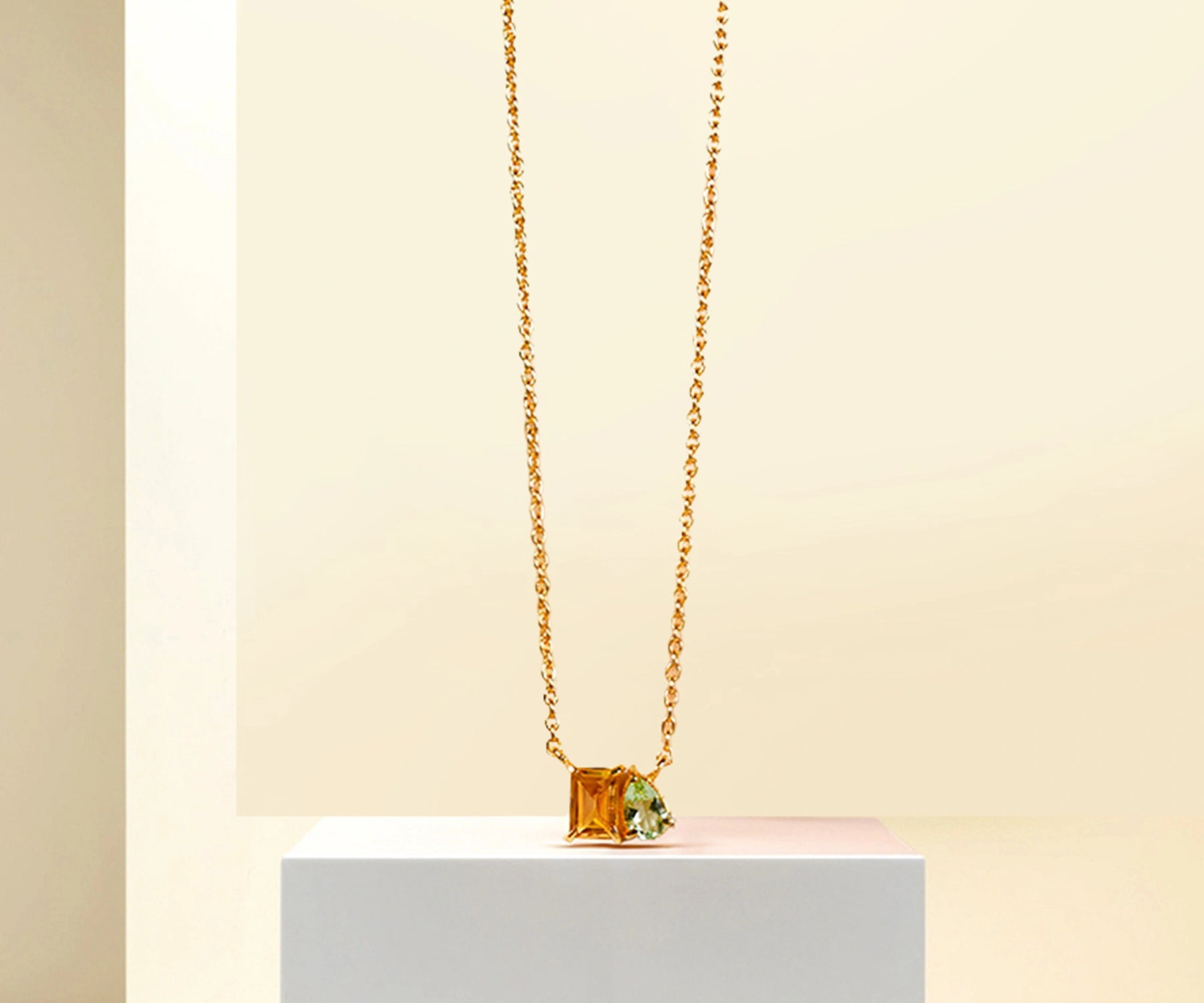 Green amethyst and citrine pendant necklace on gold chain.