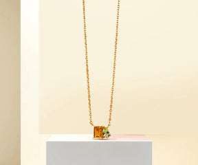 Green amethyst and citrine pendant necklace on gold chain.