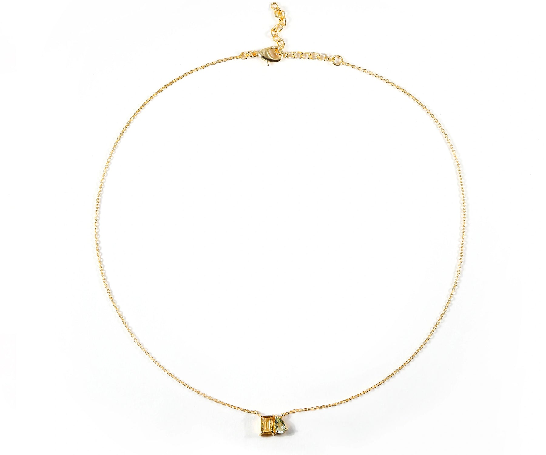 Toi Et Moi style necklace with green and yellow gemstones.