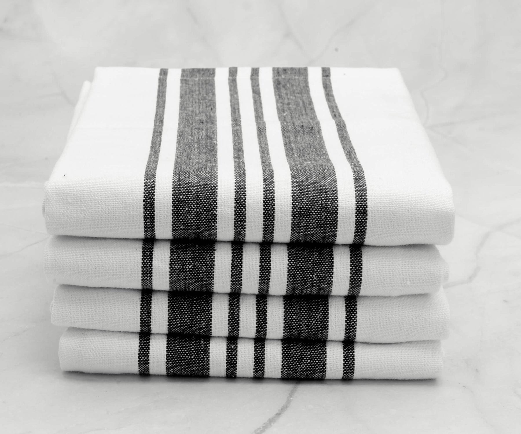 Close-up of a black striped kitchen towel stack