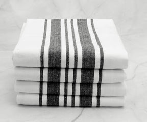 Stack of black and white striped kitchen towels neatly arranged