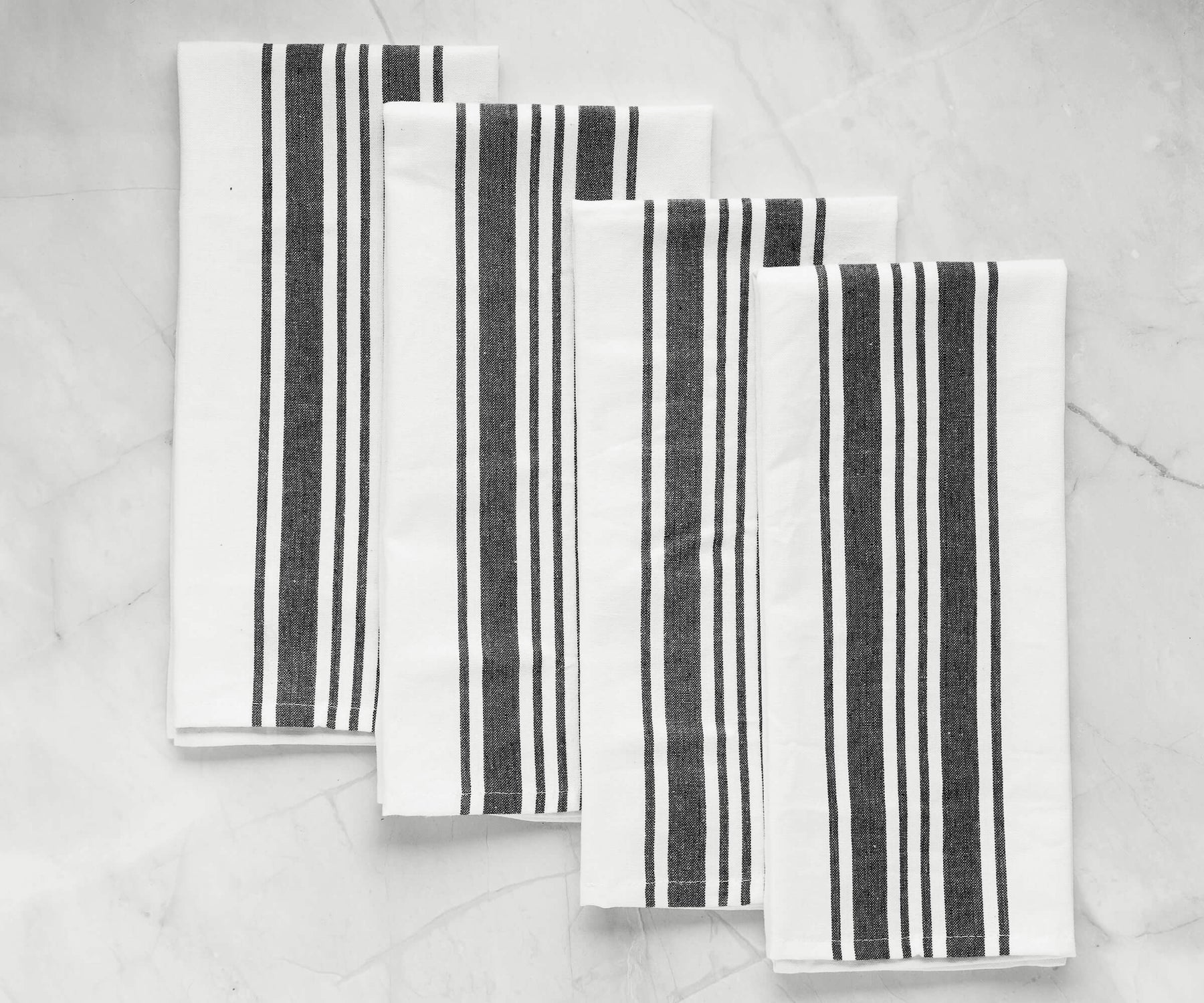 Group of black and white striped kitchen towels displayed