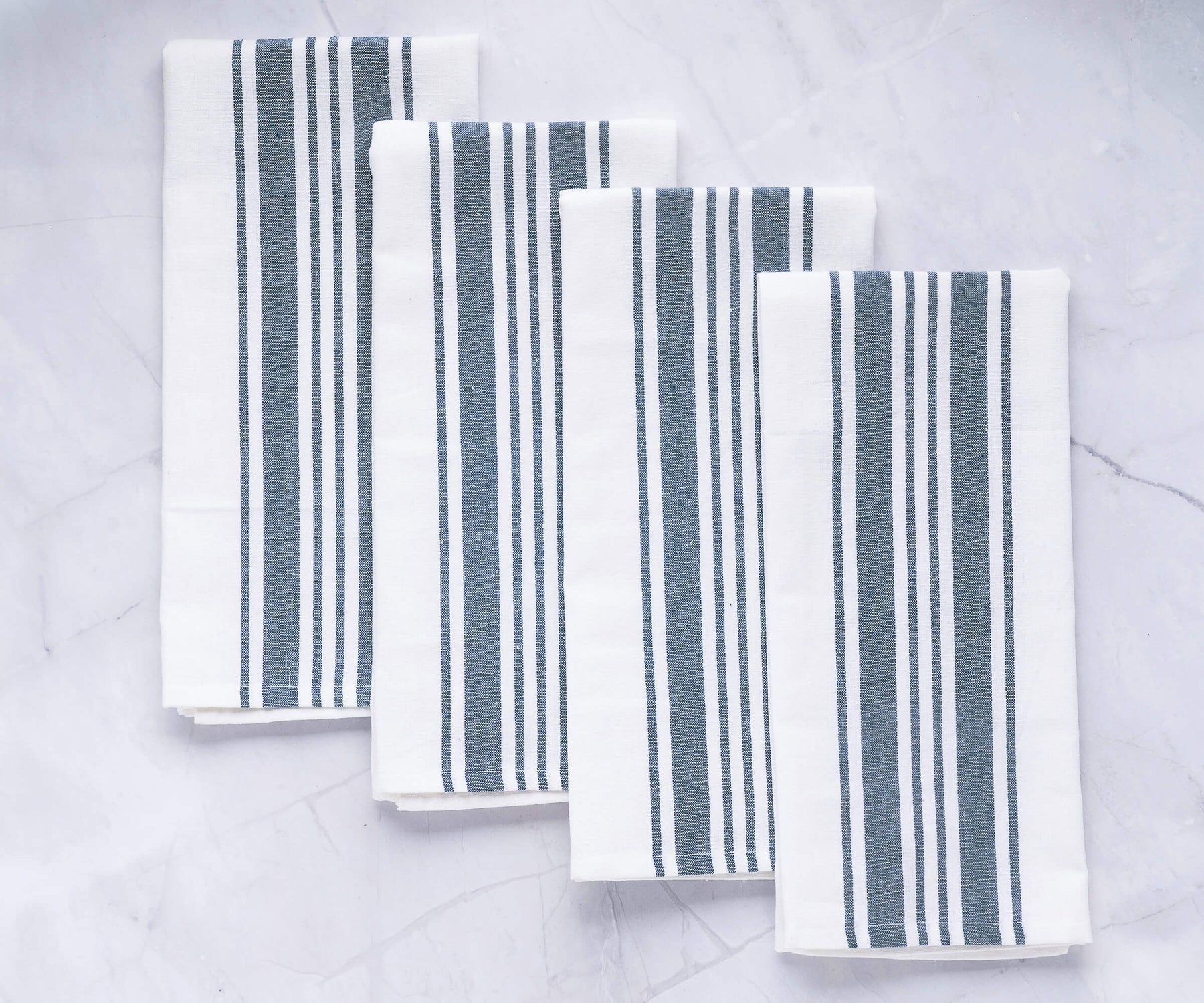 Set of four napkins featuring a blue and white striped pattern