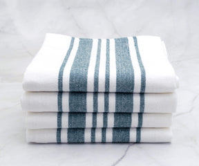 A pile of kitchen towels with blue and white stripes, showcasing their thickness