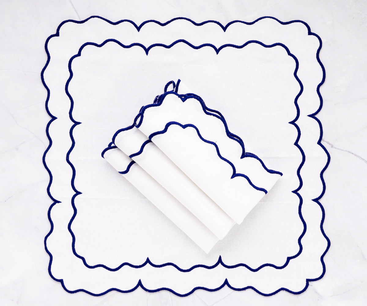 White Linen scalloped napkins adding a sophisticated flair to your table decor.