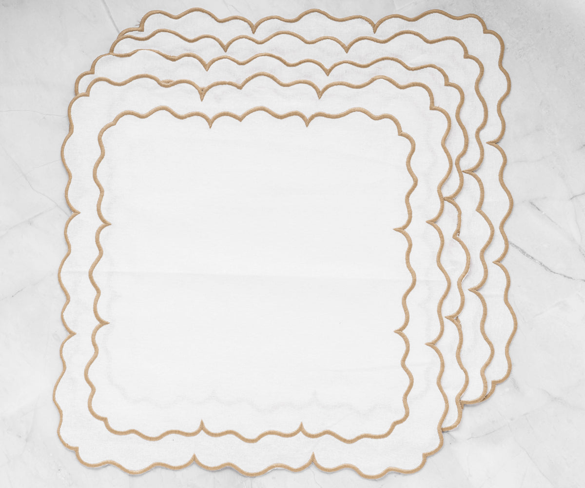 Scalloped edge linen dinner napkins adding a touch of sophistication to any meal.