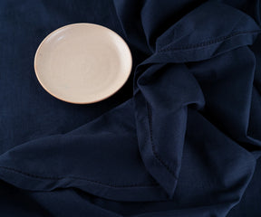 Soft and sturdy navy cotton round tablecloth for 4-6 seat setup