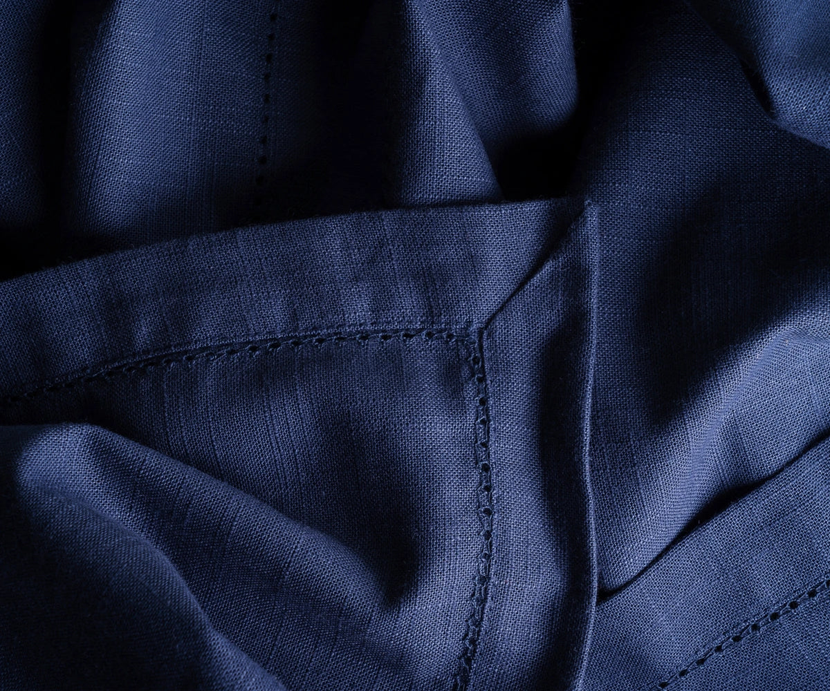 Classic navy round tablecloth paired with contrasting napkins