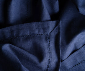 Classic navy round tablecloth paired with contrasting napkins