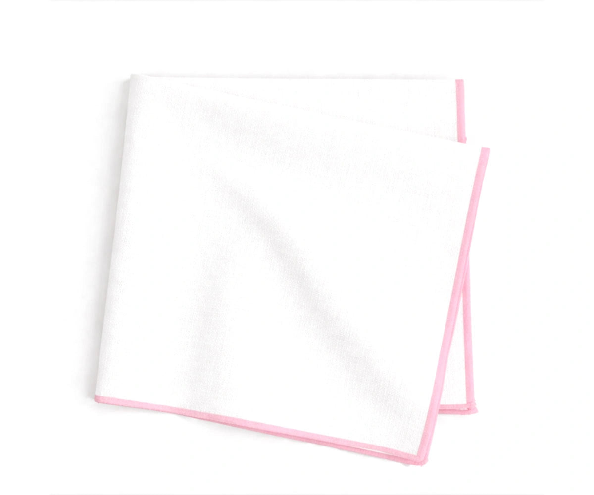 white base cotton napkins accented with pastel pink merrow stitching for refined table décor