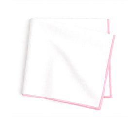 white base cotton napkins accented with pastel pink merrow stitching for refined table décor