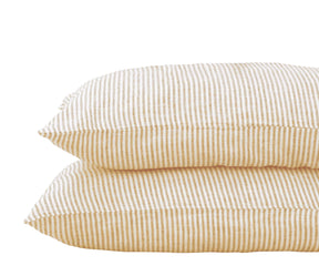 Set of 2 beige striped linen pillowcases made from 100% pure linen, displayed on a cozy neutral-toned bed.