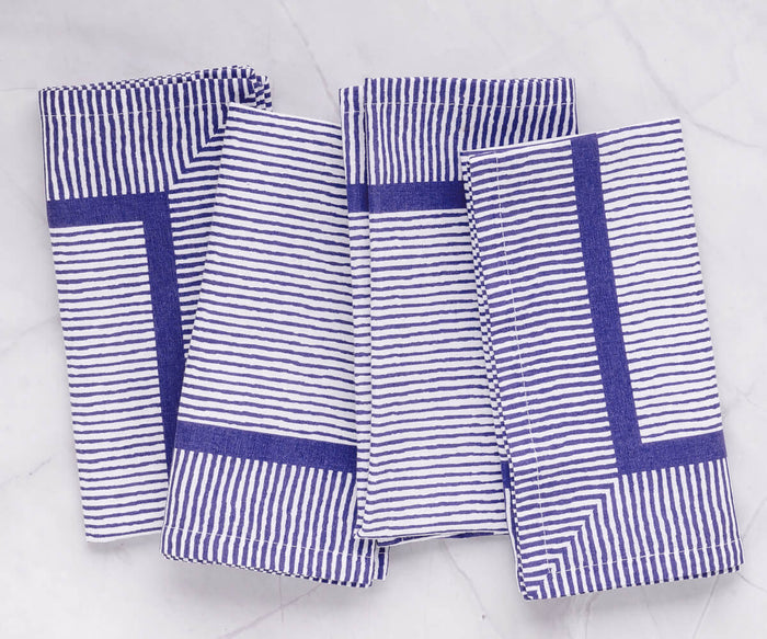 Blue and white striped napkins are versatile and can be paired with a variety of tableware