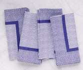 Blue and white striped napkins are versatile and can be paired with a variety of tableware