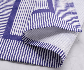 Blue striped napkins evoke a sense of nautical charm, reminiscent of the ocean and seaside vacations.