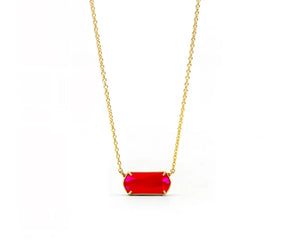 Modern feminine gold necklace featuring a pink gemstone and spring clasp