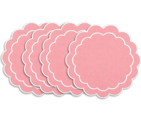 Round embroidered cotton placemat with scalloped detailing, designed to complement coordinated dining table arrangements