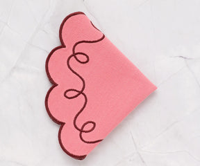Delicate pink round tablemat made from 100% cotton, finely stitched scallop edge, reusable and machine washable for daily meals and parties