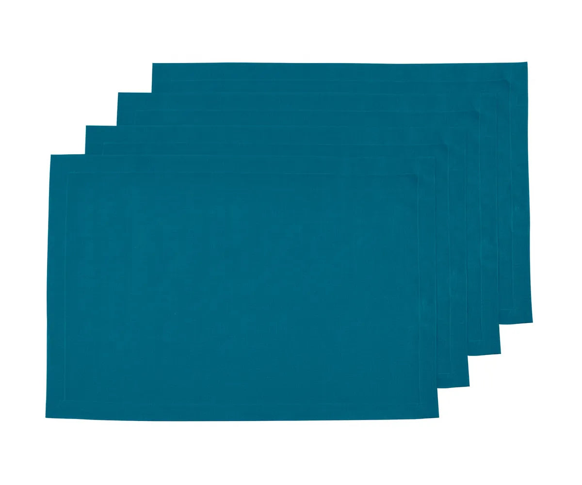 Set of teal linen placemats with a soft textured finish, neatly arranged on a dining table to add elegance, durability, and a stylish pop of color to everyday meals or special occasions.