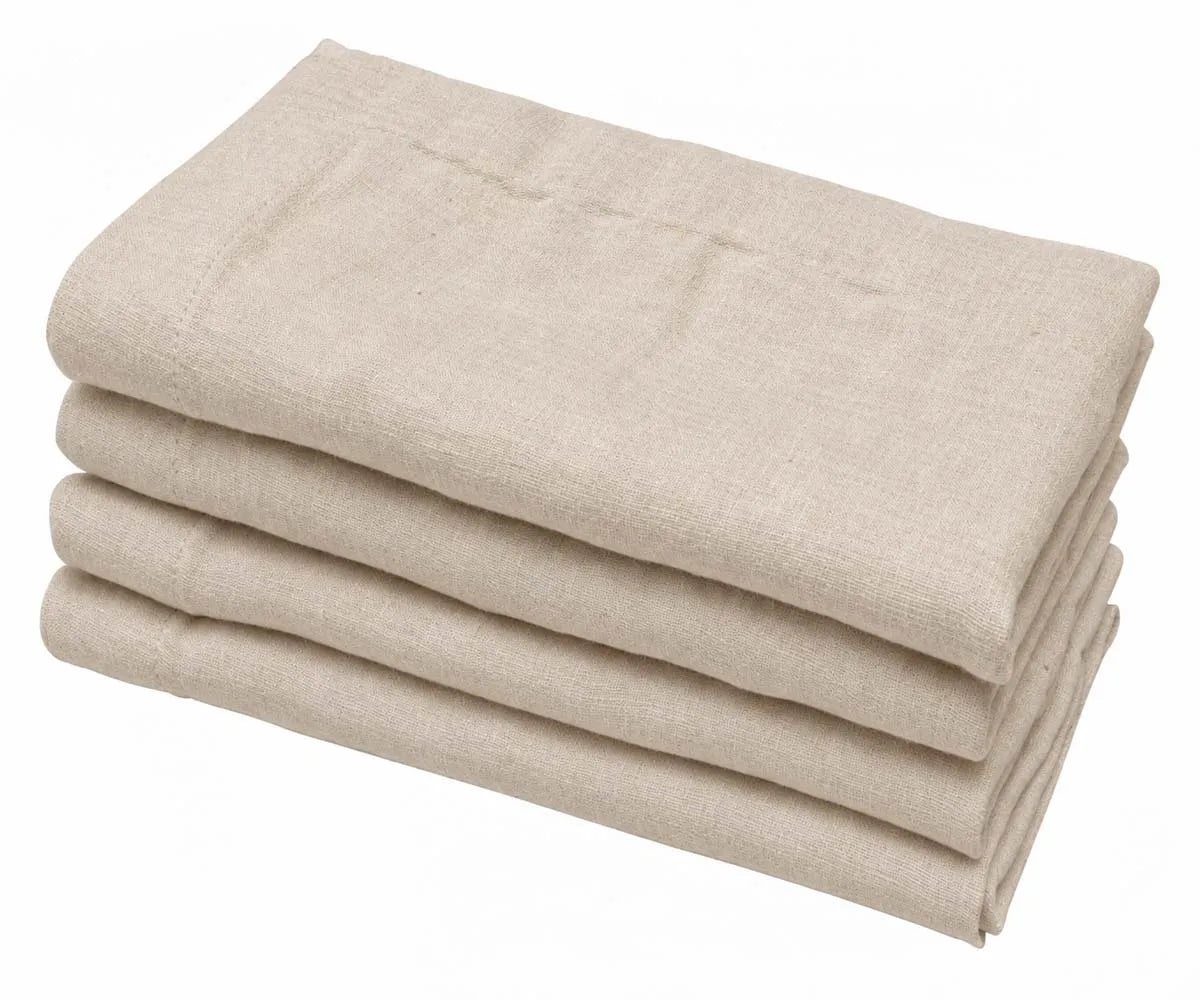 Stack of 4 natural cotton linen plain cloth dinner napkins neatly folded on a white background.