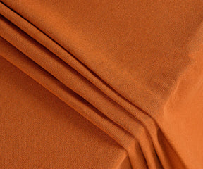 Close-up of coral cotton tablecloth fabric showing fine weave texture, soft natural fibers, and durable quality, highlighting its eco-friendly and reusable design.