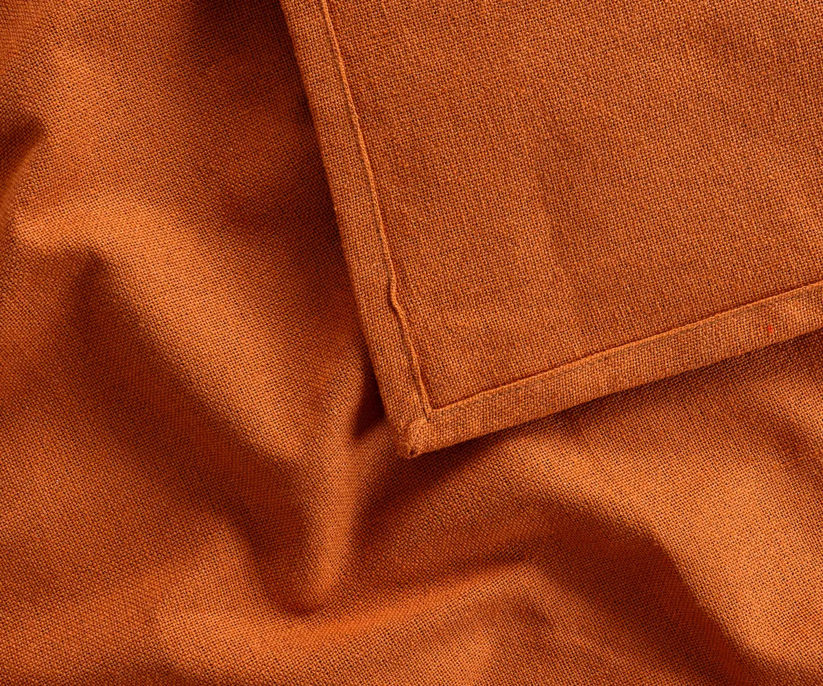Coral 100% cotton tablecloth covering a rectangular banquet table, adding a bright, elegant touch for weddings, restaurants, or holiday celebrations.
