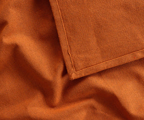 Coral 100% cotton tablecloth covering a rectangular banquet table, adding a bright, elegant touch for weddings, restaurants, or holiday celebrations.