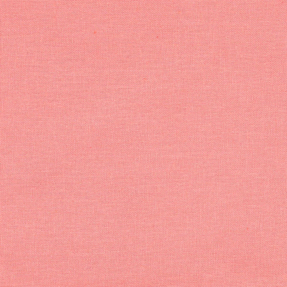 Plain pink cotton napkins, 18 x 18 inches, folded in a classic style on a wooden dining table for an elegant yet simple look.
