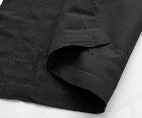 Classic black table napkins rolled and tied with silver napkin rings, ready to be used at an elegant dinner party.