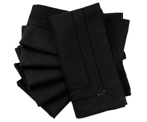 Black napkins arranged on a dinner table, offering a sleek and modern look for an upscale meal.