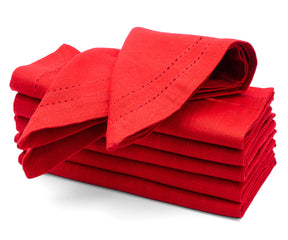 Stack of red folded napkins on a white background