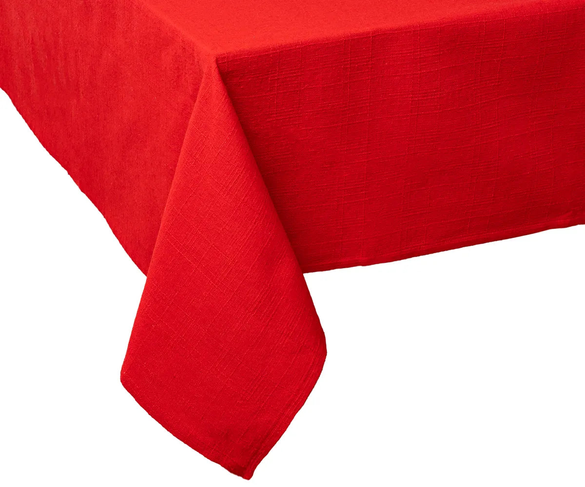 Elegant red cotton tablecloth styled on a festive dining table with candles and rustic tableware, ideal for Christmas, Thanksgiving, or family gatherings.