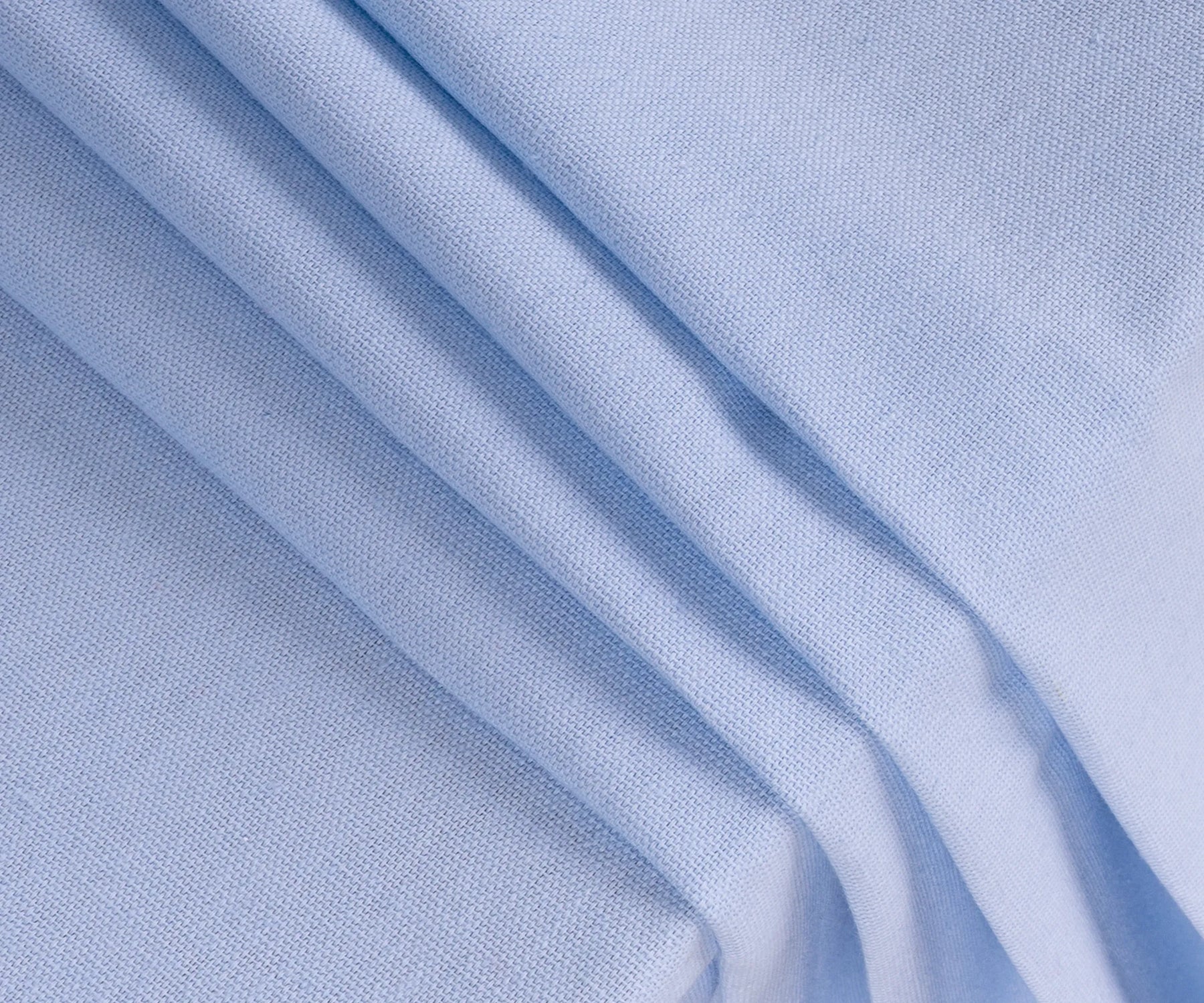 Durable sky blue cotton dining table cover displayed on a wooden table for family gatherings