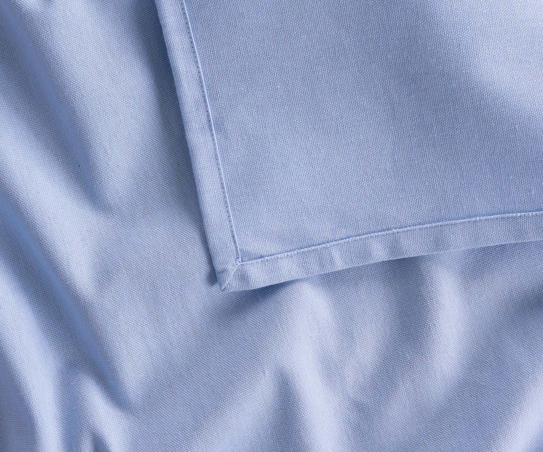 Versatile sky blue cotton rectangular tablecloth shown in bulk options for restaurants and events