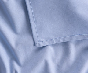 Versatile sky blue cotton rectangular tablecloth shown in bulk options for restaurants and events