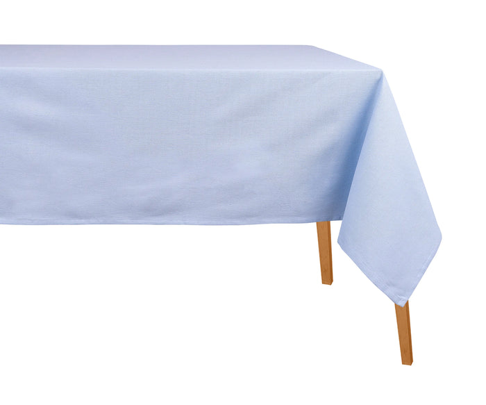 Sky blue cotton rectangular tablecloth on a dining table with scalloped napkins and floral centerpiece