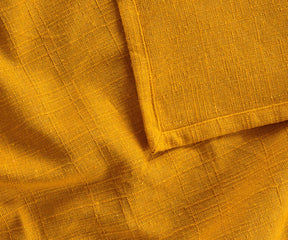 Yolk tablecloth paired with yellow napkins and natural runner