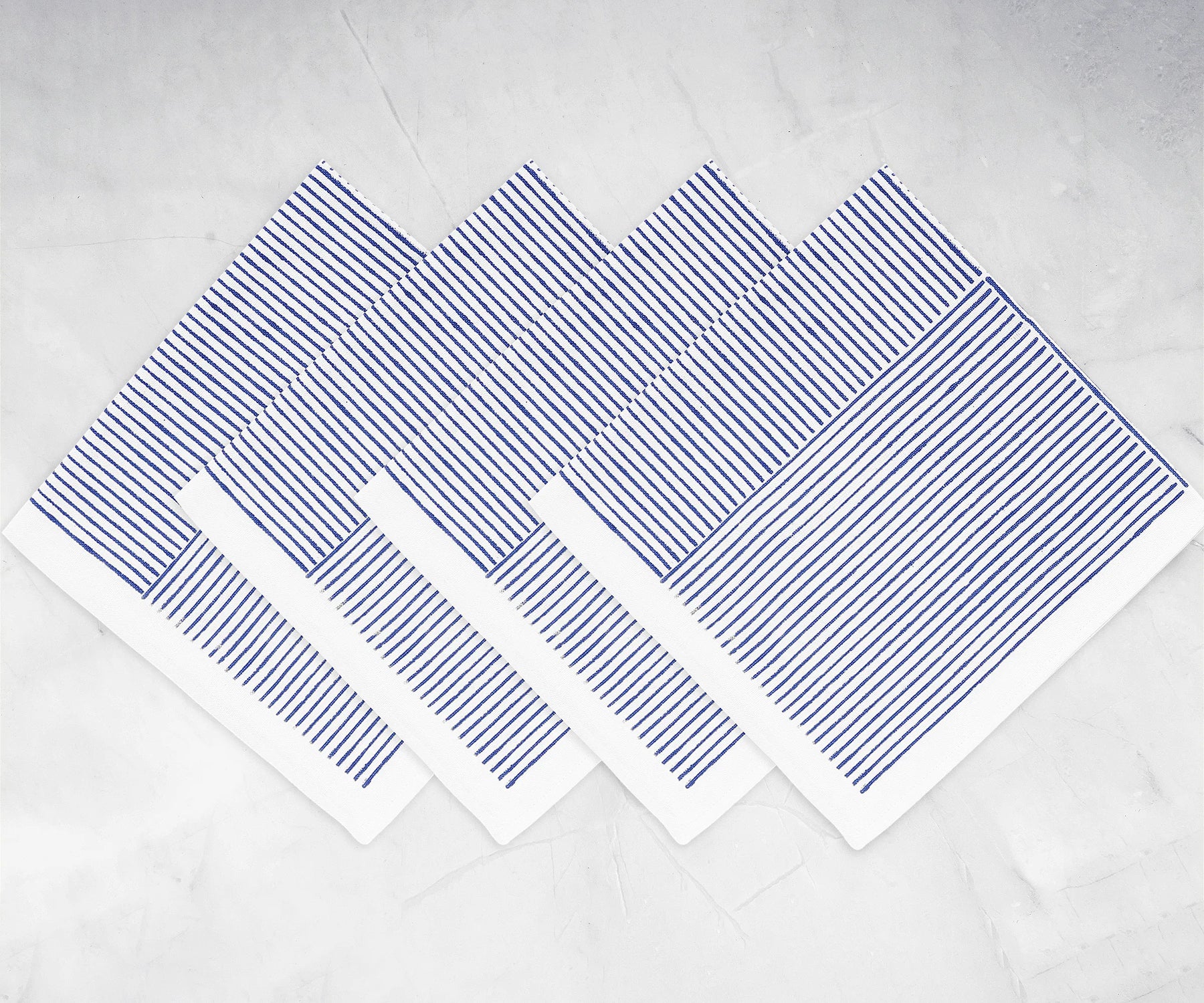 Napkin set with line print pattern displayed on a festive dining table	
