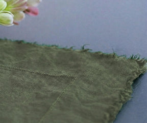 Muted green raw edge linen tablecloth styled for minimalist farmhouse tablescape