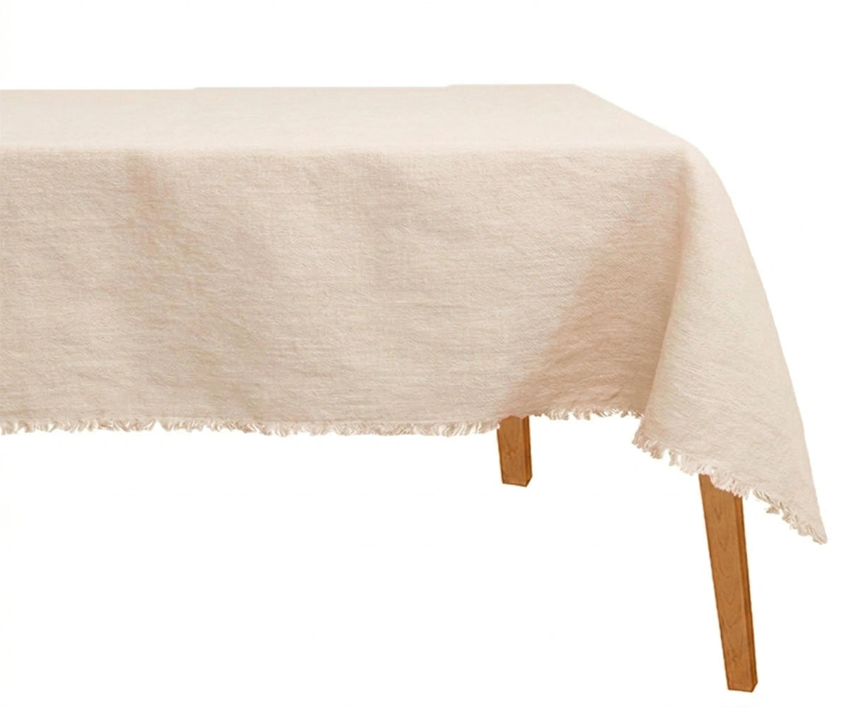 Soft ivory linen dining tablecloth styled for elegant holiday and modern minimalist tablescape