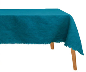 Deep teal linen tablecloth styled for holiday tablescape with ceramic dinnerware and natural wood accents