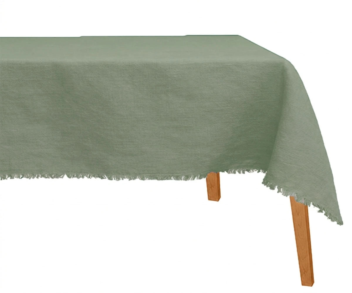 Dark green raw edge linen dining tablecloth styled with wood accents and candles