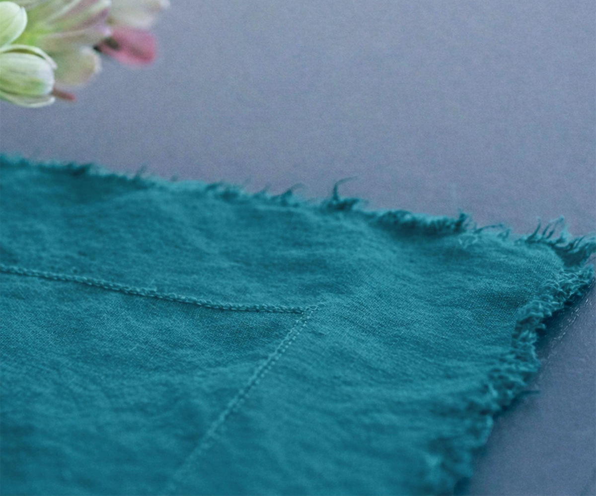 Teal 100% European linen tablecloth with soft drape and raw edge detail for elegant dining table linen
