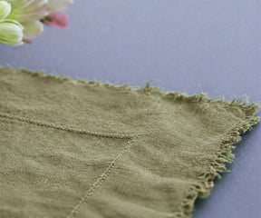 Light green European linen tablecloth styled with ceramic dishware for boho table decor