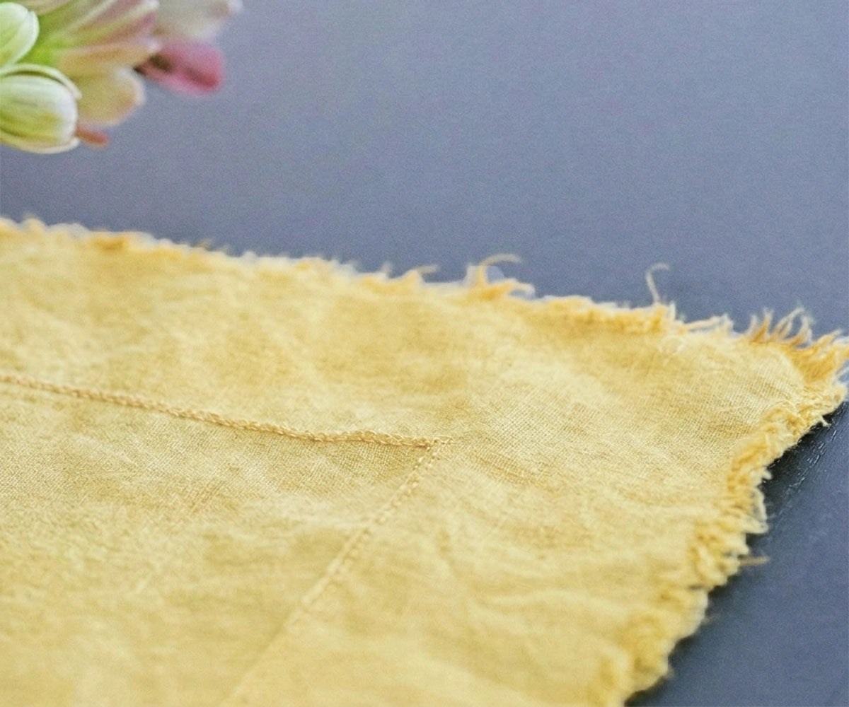 Soft yellow raw edge linen tablecloth styled for brunch tablescape and modern farmhouse dining