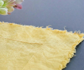 Soft yellow raw edge linen tablecloth styled for brunch tablescape and modern farmhouse dining
