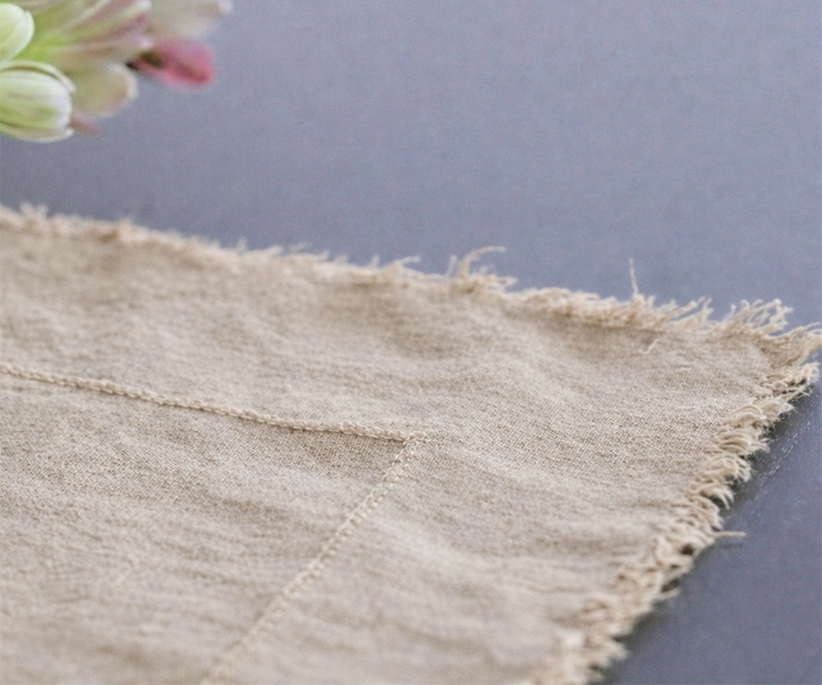 Natural flax linen tablecloth with raw edge finish for rustic farmhouse dining table styling
