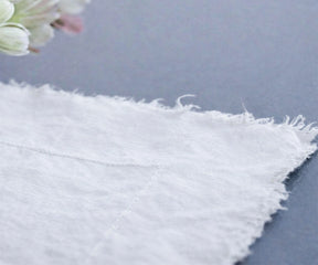 White raw edge linen tablecloth draped to floor for wedding reception and farmhouse table decor